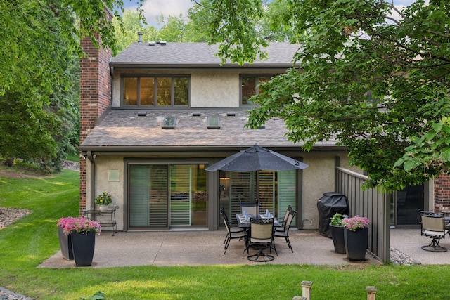 6050 Blake Ridge Rd, Edina, MN 55436 - back of house with stucco siding, a patio, and a chimney