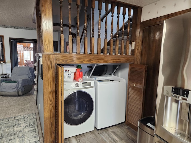 6200 37th St W, Webster, MN 55088 - laundry area featuring washer and clothes dryer, wood finished floors, and a textured ceiling