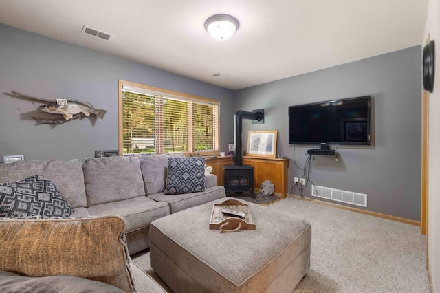 12584 County 18 SW, Brainerd, MN 56401 - living area with carpet floors, a wood stove, and baseboards