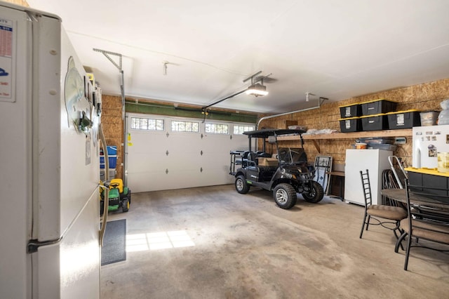 12584 County 18 SW, Brainerd, MN 56401 - garage with freestanding refrigerator, a garage door opener, and fridge