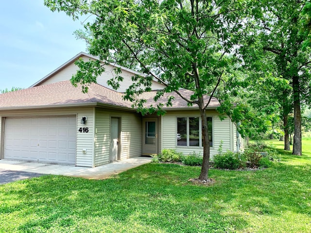 416 Rako St SW, Bemidji, MN 56601 - view of front of home with an attached garage, a front yard, asphalt driveway, and a shingled roof
