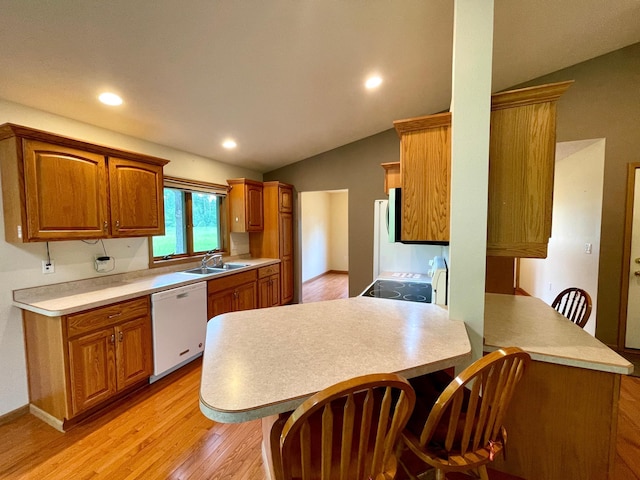 416 Rako St SW, Bemidji, MN 56601 - kitchen featuring dishwasher, a peninsula, a sink, vaulted ceiling, and light wood finished floors