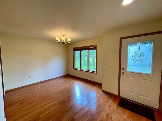 416 Rako St SW, Bemidji, MN 56601 - foyer with a chandelier, light wood-type flooring, and baseboards