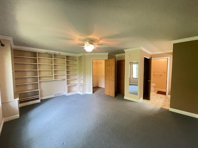 416 Rako St SW, Bemidji, MN 56601 - unfurnished bedroom with crown molding, a textured ceiling, carpet floors, baseboards, and a closet