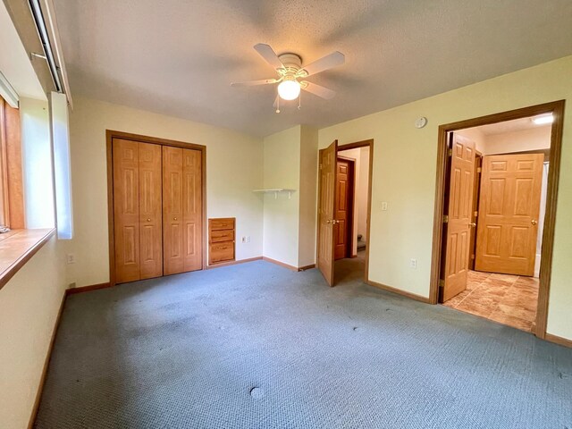 416 Rako St SW, Bemidji, MN 56601 - unfurnished bedroom with baseboards, carpet floors, a closet, and ceiling fan