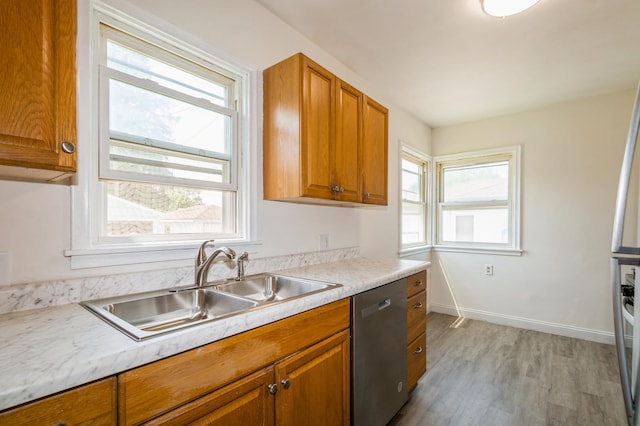1576 Nebraska Ave E, Saint Paul, MN 55106 - kitchen with dishwasher, a sink, light wood finished floors, brown cabinets, and light countertops