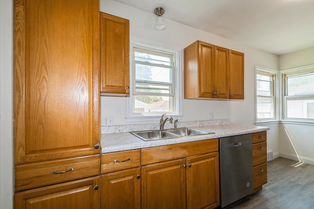 1576 Nebraska Ave E, Saint Paul, MN 55106 - kitchen featuring stainless steel dishwasher, a sink, brown cabinets, wood finished floors, and light countertops