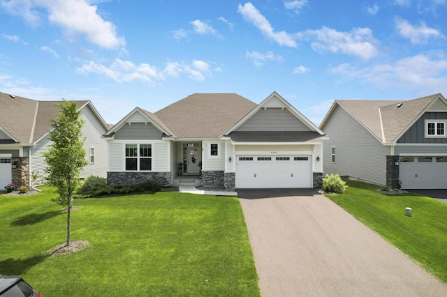 6645 91st St S, Cottage Grove, MN 55016 - craftsman-style home featuring stone siding, asphalt driveway, a front lawn, and a garage
