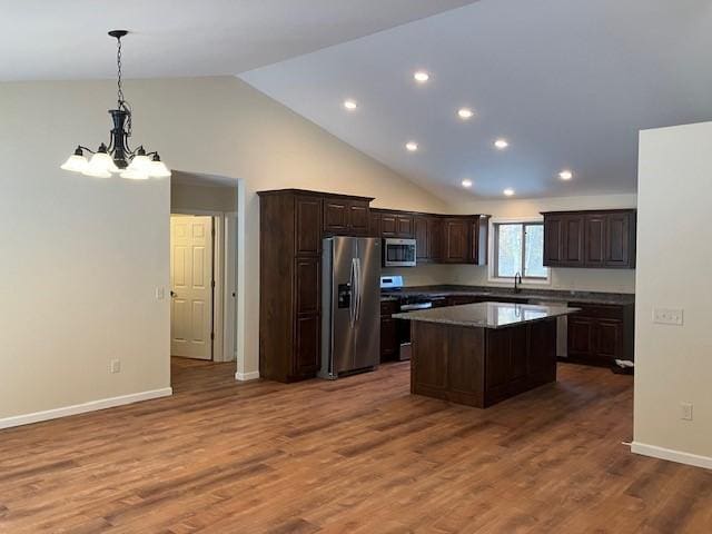 7865 Ski Chalet Dr, Breezy Point, MN 56472 - kitchen with stainless steel appliances, dark brown cabinetry, a kitchen island, recessed lighting, and pendant lighting