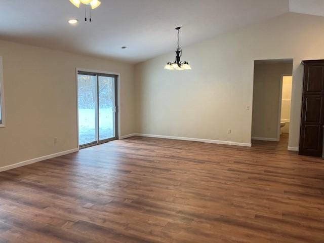 7865 Ski Chalet Dr, Breezy Point, MN 56472 - spare room featuring vaulted ceiling, a chandelier, baseboards, dark wood-type flooring, and recessed lighting