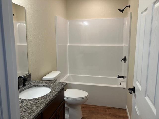 7865 Ski Chalet Dr, Breezy Point, MN 56472 - bathroom with vanity, wood finished floors, toilet, and tub / shower combination