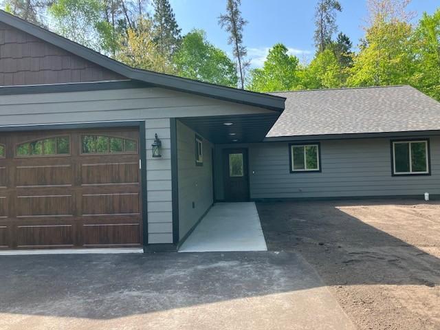 7865 Ski Chalet Dr, Breezy Point, MN 56472 - view of front of property featuring a garage, driveway, and roof with shingles