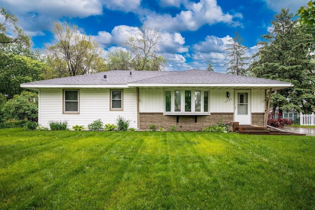 11627 Yukon St NW, Coon Rapids, MN 55433 - rear view of property featuring board and batten siding, a yard, a shingled roof, and brick siding