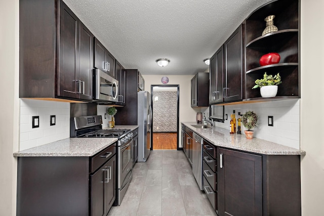 11627 Yukon St NW, Coon Rapids, MN 55433 - kitchen featuring stainless steel appliances, a sink, open shelves, tasteful backsplash, and a textured ceiling