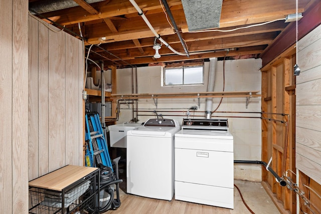 11627 Yukon St NW, Coon Rapids, MN 55433 - laundry area featuring washing machine and clothes dryer and wood walls