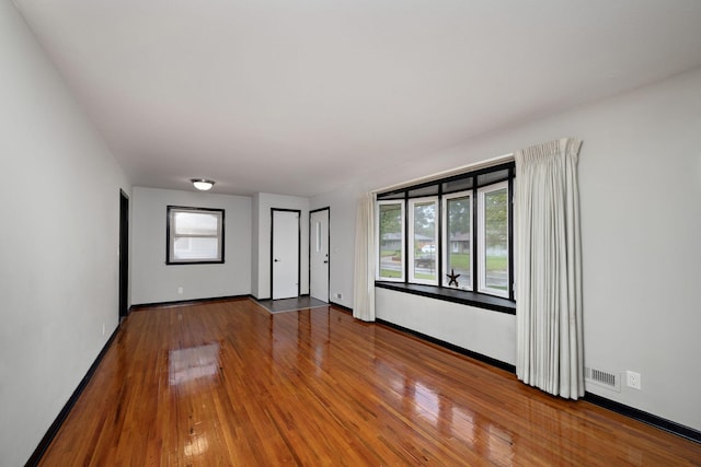 11627 Yukon St NW, Coon Rapids, MN 55433 - unfurnished room featuring wood finished floors and baseboards