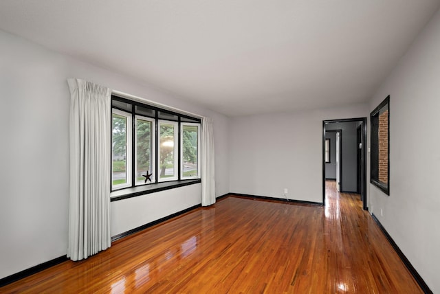 11627 Yukon St NW, Coon Rapids, MN 55433 - empty room with hardwood / wood-style flooring and baseboards