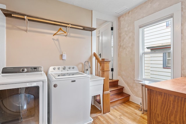 2505 Pleasant Ave, Minneapolis, MN 55404 - washroom with light wood-style flooring, washer and dryer, plenty of natural light, and baseboards