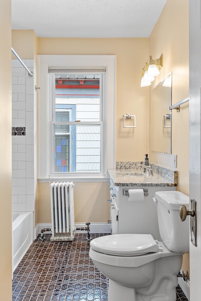 2505 Pleasant Ave, Minneapolis, MN 55404 - bathroom with radiator heating unit, toilet, vanity,  shower combination, and baseboards