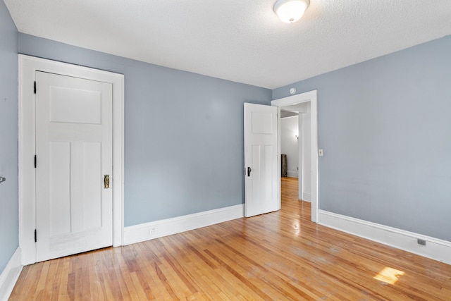 2505 Pleasant Ave, Minneapolis, MN 55404 - empty room featuring baseboards, wood-type flooring, and a textured ceiling