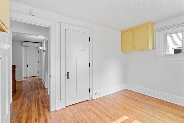 2505 Pleasant Ave, Minneapolis, MN 55404 - empty room featuring a wall unit AC, light wood-style flooring, baseboards, and a smoke detector
