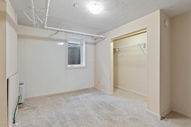 2505 Pleasant Ave, Minneapolis, MN 55404 - unfurnished bedroom featuring carpet flooring, a textured ceiling, a closet, and baseboards