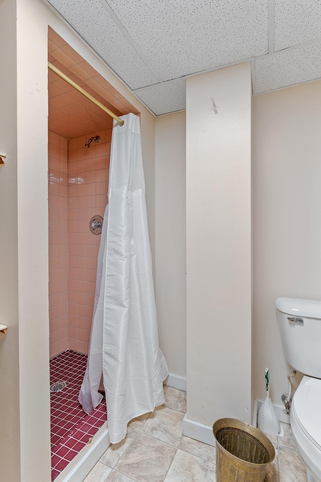 2505 Pleasant Ave, Minneapolis, MN 55404 - full bath with a paneled ceiling, toilet, a shower stall, and baseboards