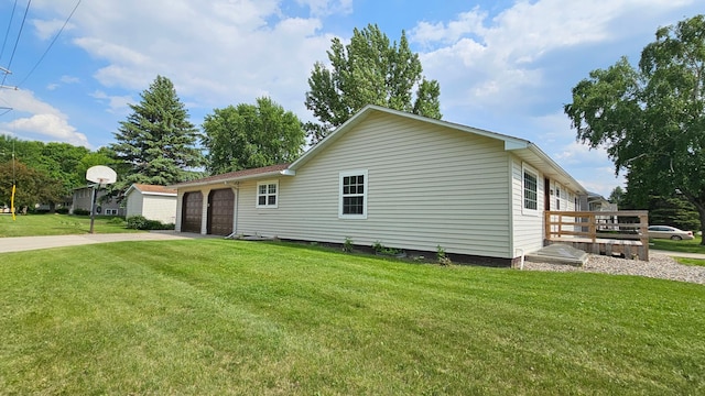 111 10th Ave SE, Elbow Lake, MN 56531 - view of property exterior featuring driveway, a yard, an attached garage, and a wooden deck