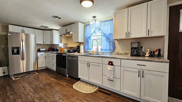 111 10th Ave SE, Elbow Lake, MN 56531 - kitchen featuring stainless steel appliances, under cabinet range hood, a sink, white cabinetry, and dark wood-style flooring