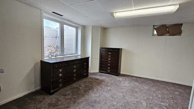 111 10th Ave SE, Elbow Lake, MN 56531 - unfurnished bedroom featuring dark carpet and a paneled ceiling