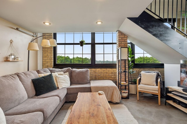 730 Stinson Blvd Unit 425, Minneapolis, MN 55413 - living room with finished concrete floors, brick wall, healthy amount of natural light, and recessed lighting