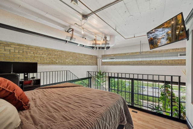730 Stinson Blvd Unit 425, Minneapolis, MN 55413 - bedroom with wood finished floors and brick wall