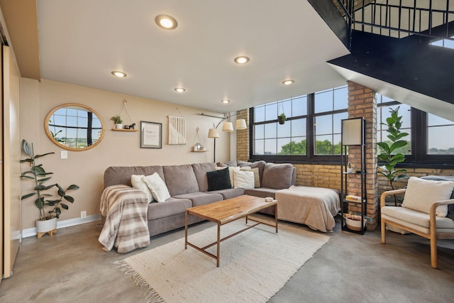 730 Stinson Blvd Unit 425, Minneapolis, MN 55413 - living room featuring finished concrete floors, baseboards, brick wall, and recessed lighting