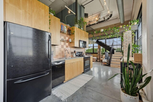 730 Stinson Blvd Unit 425, Minneapolis, MN 55413 - kitchen featuring black appliances, a sink, light brown cabinetry, concrete floors, and tasteful backsplash