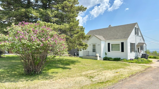 2212 Springvale Ct, Duluth, MN 55811 - view of side of home featuring a shingled roof, a lawn, and a chimney