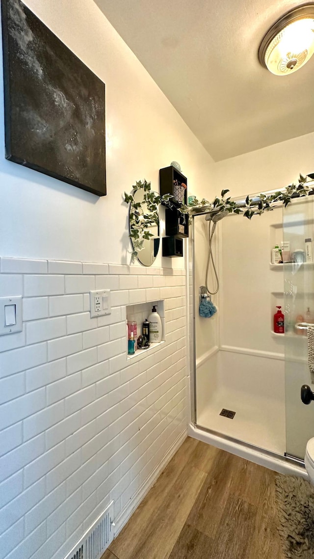 2212 Springvale Ct, Duluth, MN 55811 - full bathroom with wood finished floors, a shower stall, and toilet