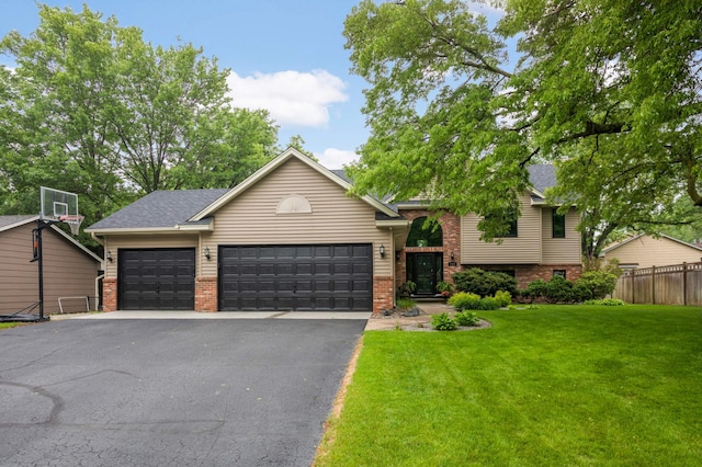 1366 140th Ln NW, Andover, MN 55304 - view of front facade featuring driveway, brick siding, an attached garage, and a shingled roof