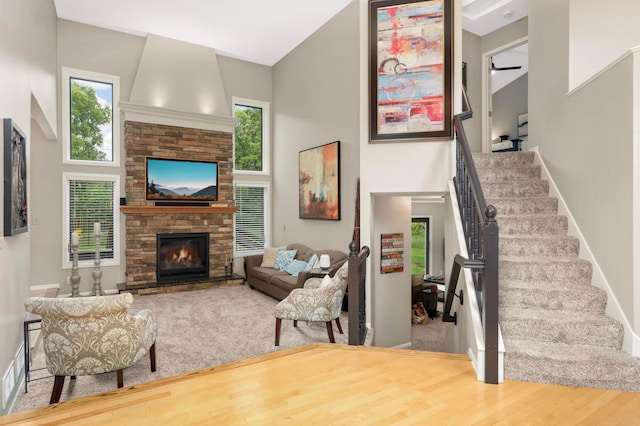 1366 140th Ln NW, Andover, MN 55304 - living room with a towering ceiling, stairs, a large fireplace, baseboards, and wood finished floors