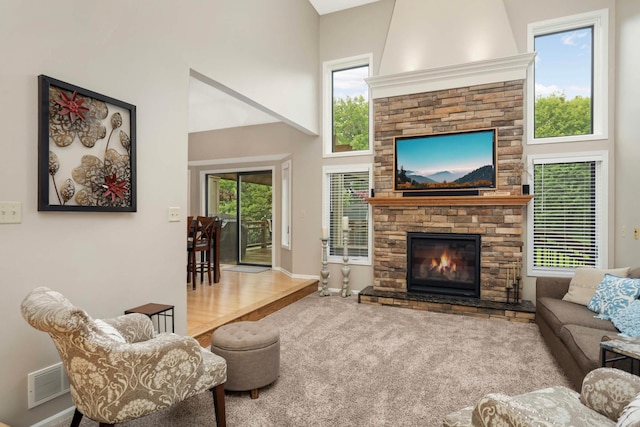1366 140th Ln NW, Andover, MN 55304 - carpeted living area with a high ceiling, a fireplace, plenty of natural light, and baseboards