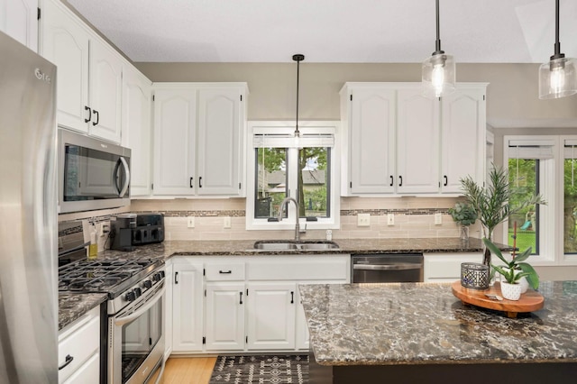 1366 140th Ln NW, Andover, MN 55304 - kitchen with appliances with stainless steel finishes, a sink, white cabinets, and dark stone counters