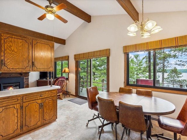 1474 Shamineau Dr, Motley, MN 56466 - dining room featuring beamed ceiling, a glass covered fireplace, a ceiling fan, a chandelier, and high vaulted ceiling