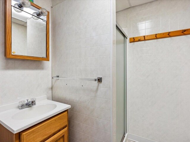 1474 Shamineau Dr, Motley, MN 56466 - full bath with a shower stall, vanity, and tile walls