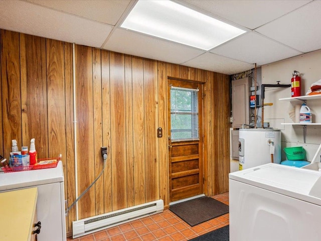 1474 Shamineau Dr, Motley, MN 56466 - laundry area with water heater, baseboard heating, washing machine and dryer, wood walls, and tile patterned flooring