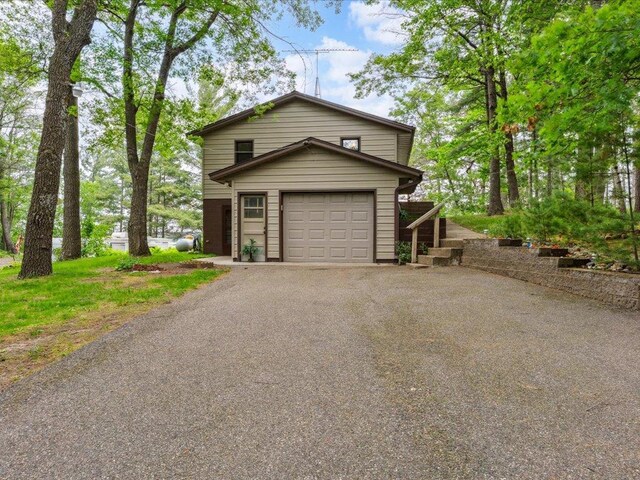 1474 Shamineau Dr, Motley, MN 56466 - view of front of property with a garage and asphalt driveway