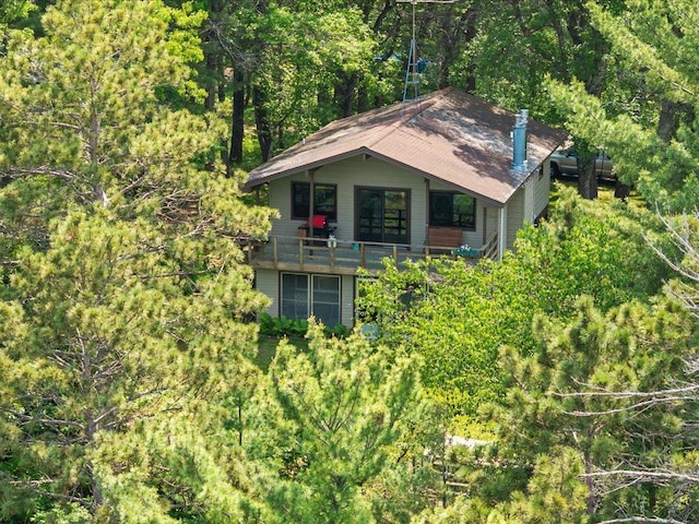1474 Shamineau Dr, Motley, MN 56466 - view of front facade with a balcony and a forest view
