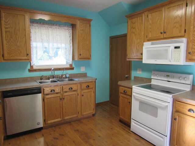 457 Rohrer St, Round Lake, MN 56167 - kitchen with white appliances, a sink, light wood-type flooring, light countertops, and vaulted ceiling