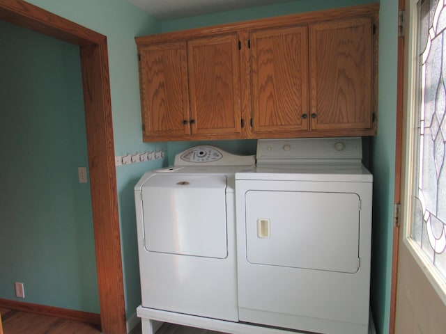 457 Rohrer St, Round Lake, MN 56167 - laundry area featuring washer and dryer, cabinet space, wood finished floors, and baseboards