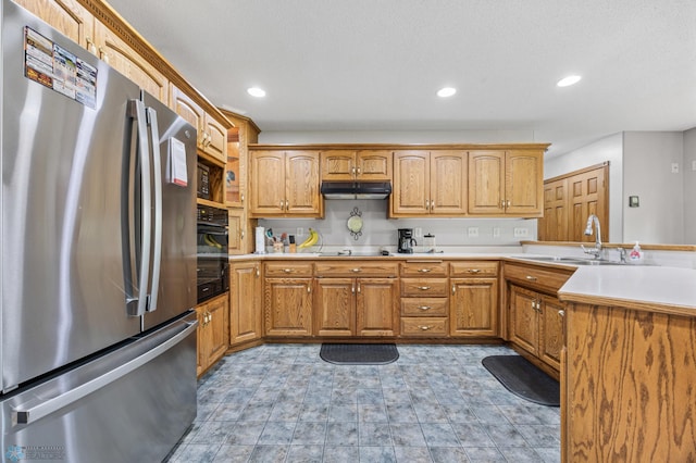 18000 10th St SW, Hawley, MN 56549 - kitchen with black appliances, under cabinet range hood, a sink, a peninsula, and light countertops