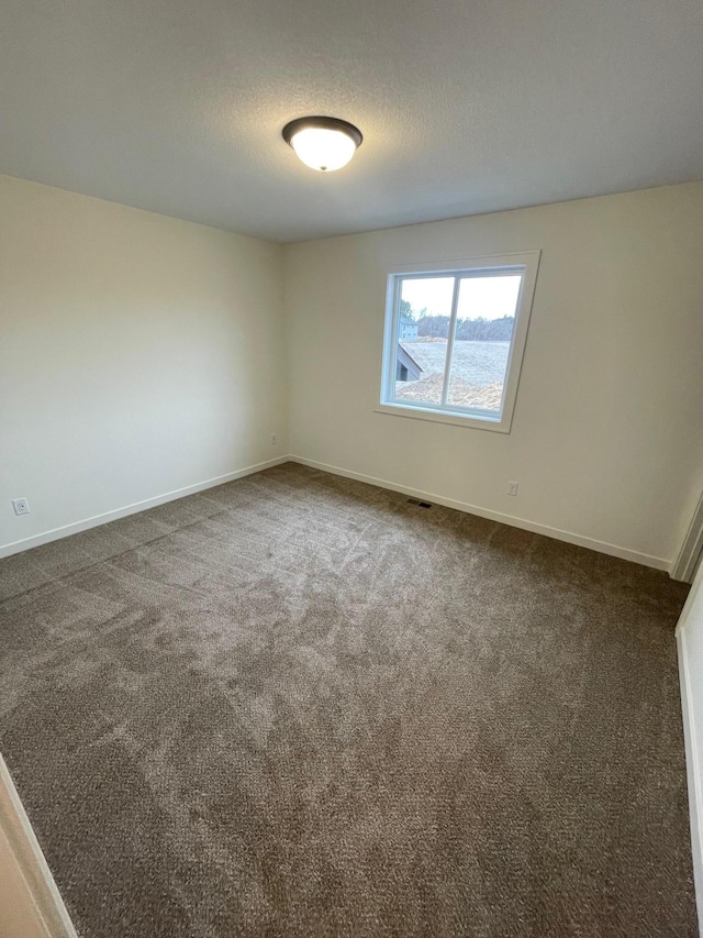 32755 Naples St NE, Cambridge, MN 55008 - spare room featuring dark carpet and baseboards
