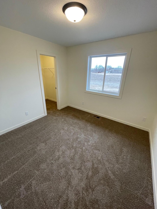 32755 Naples St NE, Cambridge, MN 55008 - spare room featuring dark carpet and baseboards
